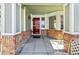 Red front door entryway with a brick-lined porch at 1894 S Marshall Cir, Lakewood, CO 80232