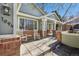 Inviting front porch with rocking chairs, brick accents, and landscaping at 1894 S Marshall Cir, Lakewood, CO 80232