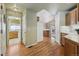 Spacious hallway with wood floors, leading to kitchen and laundry room at 1894 S Marshall Cir, Lakewood, CO 80232