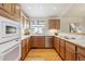 Kitchen with light wood cabinets, hardwood floors, and stainless steel appliances at 1894 S Marshall Cir, Lakewood, CO 80232