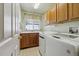 Laundry room with washer, dryer, and wood cabinets at 1894 S Marshall Cir, Lakewood, CO 80232