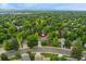 Expansive view showing home nestled among trees with mountain view in the distance at 3765 E Easter Dr, Centennial, CO 80122