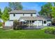 Exterior view of a home showcasing the backyard, patio, lush lawn, and hot tub at 3765 E Easter Dr, Centennial, CO 80122