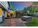Backyard featuring a hot tub, patio area, mature trees, and a serene outdoor space at 3765 E Easter Dr, Centennial, CO 80122