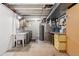 Utility room in basement with cabinets, laundry machines, water heater and utility sink at 3765 E Easter Dr, Centennial, CO 80122