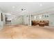 Spacious finished basement with carpet, recessed lighting, stairs and brown sectional sofa with ottoman at 3765 E Easter Dr, Centennial, CO 80122