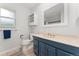 Well-lit bathroom with a blue vanity, white countertop, large mirror, and modern fixtures at 3765 E Easter Dr, Centennial, CO 80122