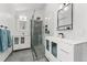 Sleek bathroom with glass-enclosed shower, dual vanities, modern fixtures, and great lighting at 3765 E Easter Dr, Centennial, CO 80122