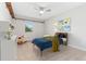 Bright bedroom featuring neutral walls, ceiling fan, playful animal-themed artwork, and a rocking horse at 3765 E Easter Dr, Centennial, CO 80122