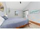 Serene bedroom with a sliding door to the bathroom, a window, and wood floors at 3765 E Easter Dr, Centennial, CO 80122