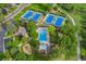 Aerial view of community pool and tennis courts surrounded by lush greenery and trees at 3765 E Easter Dr, Centennial, CO 80122