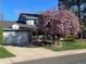 Charming home featuring a well-manicured lawn and blooming tree in front yard at 3765 E Easter Dr, Centennial, CO 80122