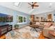 Inviting living room with a fireplace, a ceiling fan, skylights, hardwood floors and a TV at 3765 E Easter Dr, Centennial, CO 80122