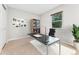 Office features a black desk, comfortable office chair, bookshelf, and a view from the bright window at 3765 E Easter Dr, Centennial, CO 80122