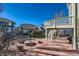 Backyard featuring a stone patio, fire pit, and raised deck for outdoor relaxation and entertainment at 2903 Dragonfly Ct, Castle Rock, CO 80109