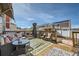Relaxing back deck with patio furniture, a grill, and a beautiful outdoor area perfect for entertaining at 5541 Killarney Ct, Denver, CO 80249