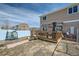 Backyard view showcasing a wooden deck, fenced yard, and outdoor space perfect for relaxation and enjoyment at 5541 Killarney Ct, Denver, CO 80249