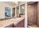 This bathroom showcases a stylish vanity, a spacious shower, and decorative mirrors at 5541 Killarney Ct, Denver, CO 80249