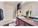 The bathroom showcases a clean design with a tub, vanity, and a framed mirror at 5541 Killarney Ct, Denver, CO 80249