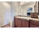 The bathroom has a vanity with a sink, a toilet, and pink cabinets at 5541 Killarney Ct, Denver, CO 80249