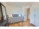 Stylish bedroom with a black daybed, a full-length mirror, and an open closet at 5541 Killarney Ct, Denver, CO 80249