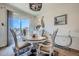 Bright dining area featuring a modern chandelier, stylish decor and patio access at 5541 Killarney Ct, Denver, CO 80249