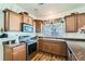 Kitchen featuring stainless steel appliances and hardwood floors with bar stool seating and lots of natural light at 5541 Killarney Ct, Denver, CO 80249