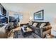 Comfortable living area featuring a plush sofa, a modern desk setup, and a large TV at 5541 Killarney Ct, Denver, CO 80249