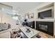 Cozy living room featuring a fireplace and seamless open floor plan to the dining area at 5541 Killarney Ct, Denver, CO 80249