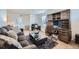 Inviting living room area features a comfy couch, armchair, and built-in desk for a cozy and functional space at 5541 Killarney Ct, Denver, CO 80249
