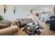 Comfortable living room featuring neutral decor and open layout to dining area at 5541 Killarney Ct, Denver, CO 80249