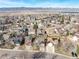 An aerial view of a suburban neighborhood with mountain views on a clear day at 9905 Foxhill Cir, Highlands Ranch, CO 80129
