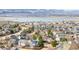 An aerial view of a neighborhood with homes with solar panels and a lake in the background at 9905 Foxhill Cir, Highlands Ranch, CO 80129