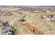 An aerial view of a community with walking trails and a pond, surrounded by open space at 9905 Foxhill Cir, Highlands Ranch, CO 80129