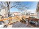 Enjoyable outdoor living space with a wood deck, metal railing, and backyard view at 9905 Foxhill Cir, Highlands Ranch, CO 80129