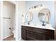 Stylish bathroom with a vanity, dual sinks, and updated lighting fixtures at 9905 Foxhill Cir, Highlands Ranch, CO 80129