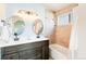 Beautiful bathroom showcasing a dual sink vanity and tub with tiled shower at 9905 Foxhill Cir, Highlands Ranch, CO 80129