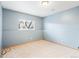 Empty bedroom with light blue walls, carpet, a double-hung window, and white trim at 9905 Foxhill Cir, Highlands Ranch, CO 80129