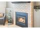 Close up of fireplace with brick surround at 9905 Foxhill Cir, Highlands Ranch, CO 80129