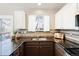 Beautiful kitchen featuring granite countertops, stylish backsplash, and ample cabinet space at 9905 Foxhill Cir, Highlands Ranch, CO 80129