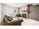 Cozy living room with a brick fireplace, and a comfortable seating area at 9905 Foxhill Cir, Highlands Ranch, CO 80129
