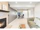 Comfortable living room with a fireplace, sofa, table with chairs, and white storage closet at 9905 Foxhill Cir, Highlands Ranch, CO 80129