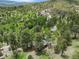 Aerial view of property surrounded by lush greenery in a serene mountain setting at 32171 Lodgepole Dr, Evergreen, CO 80439