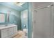 Bright bathroom features a white vanity, matching toilet, and glass-enclosed shower at 32171 Lodgepole Dr, Evergreen, CO 80439