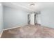 Spacious bedroom with neutral carpet, light blue walls and trim, and a ceiling light at 32171 Lodgepole Dr, Evergreen, CO 80439