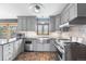 Beautiful kitchen with stainless steel appliances, gray cabinets, and mountain view window at 32171 Lodgepole Dr, Evergreen, CO 80439