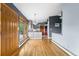 Living room with gray walls, wood floors, exterior door, and a view into the kitchen at 32171 Lodgepole Dr, Evergreen, CO 80439