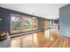 Spacious living room featuring hardwood floors, large view windows, and gray wall paint at 32171 Lodgepole Dr, Evergreen, CO 80439
