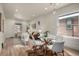 Bright dining area with a glass table and hardwood floors, seamlessly connected to the adjacent living room at 1439 S Sherman St, Denver, CO 80210