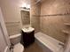 Bathroom with tiled walls, a tub, and a vanity with a modern faucet at 6176 S Adams Dr, Centennial, CO 80121